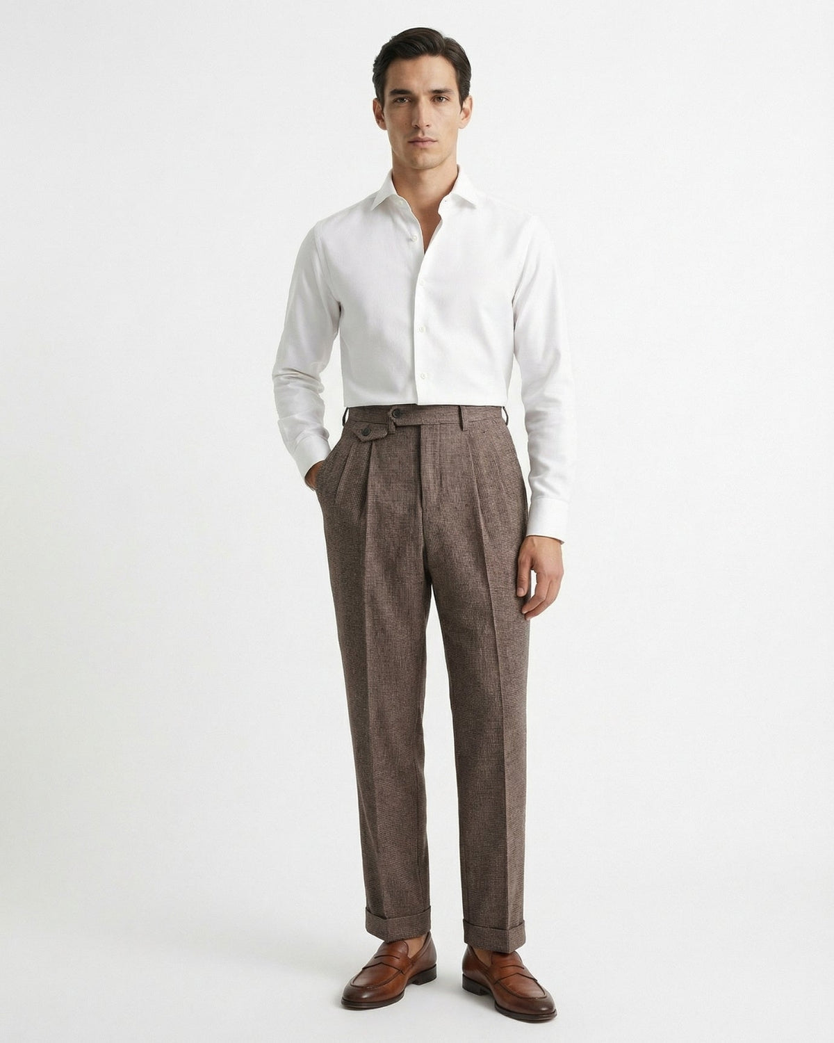 Man wearing brown houndstooth merino wool double pleated trousers with white dress shirt and leather loafers