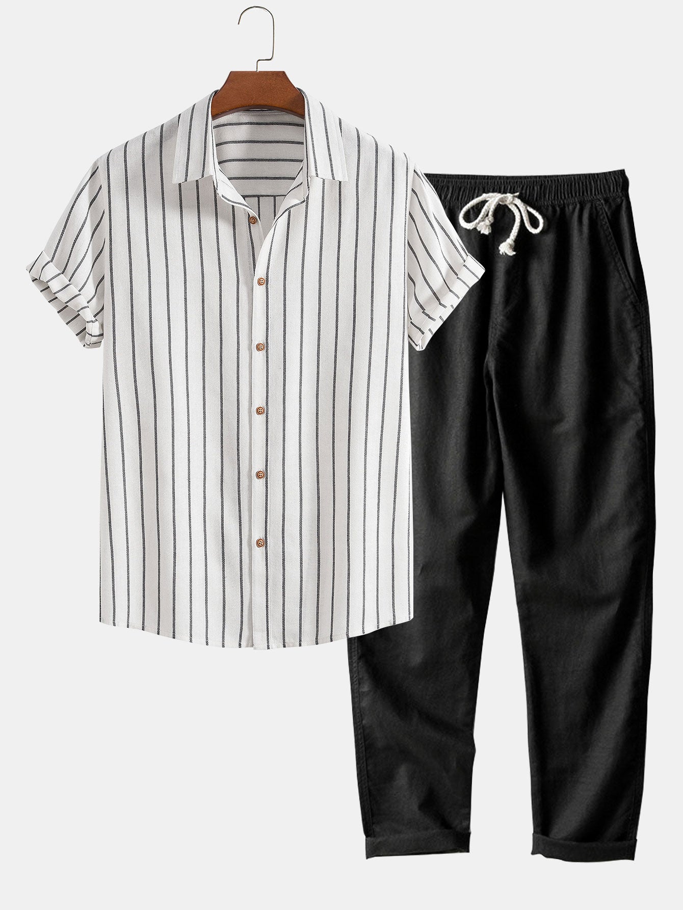 Men's black and white contrast linen-blend set, combining a light-colored shirt with dark tailored pants.