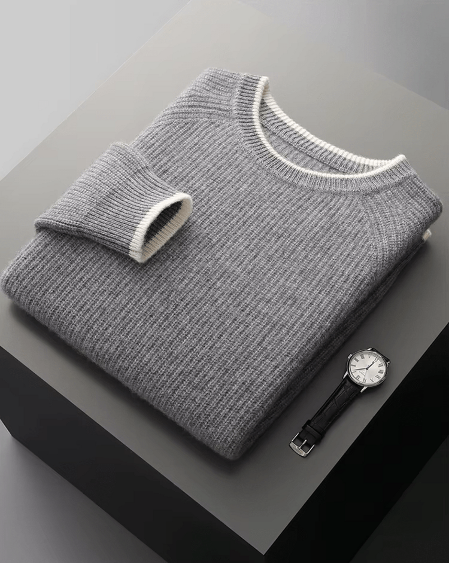 Charcoal gray premium merino wool crewneck featuring a light gray layered-effect bottom edge.