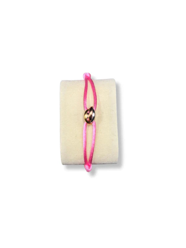 Pink bracelet with a gold charm on a white background