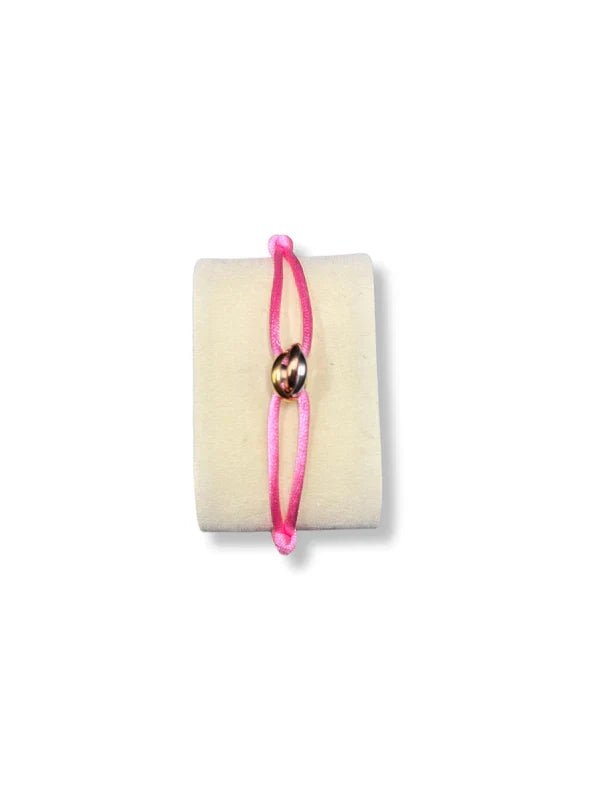 Pink bracelet with a gold charm on a white background