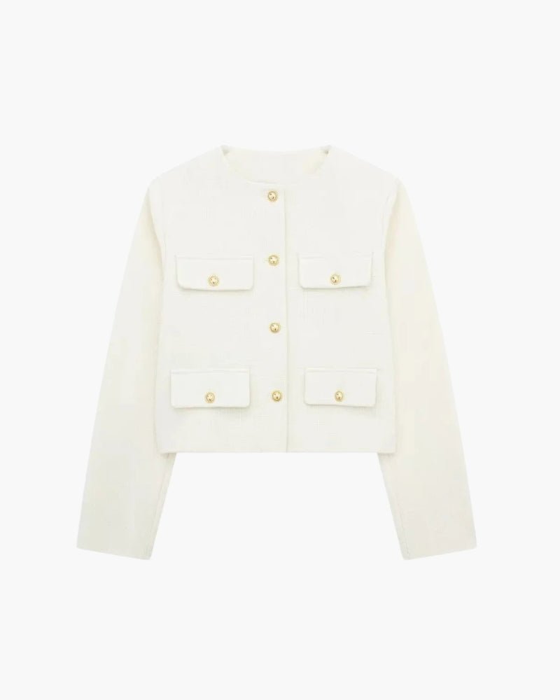 Close-up of chic white cropped textured blazer with gold-tone embossed buttons