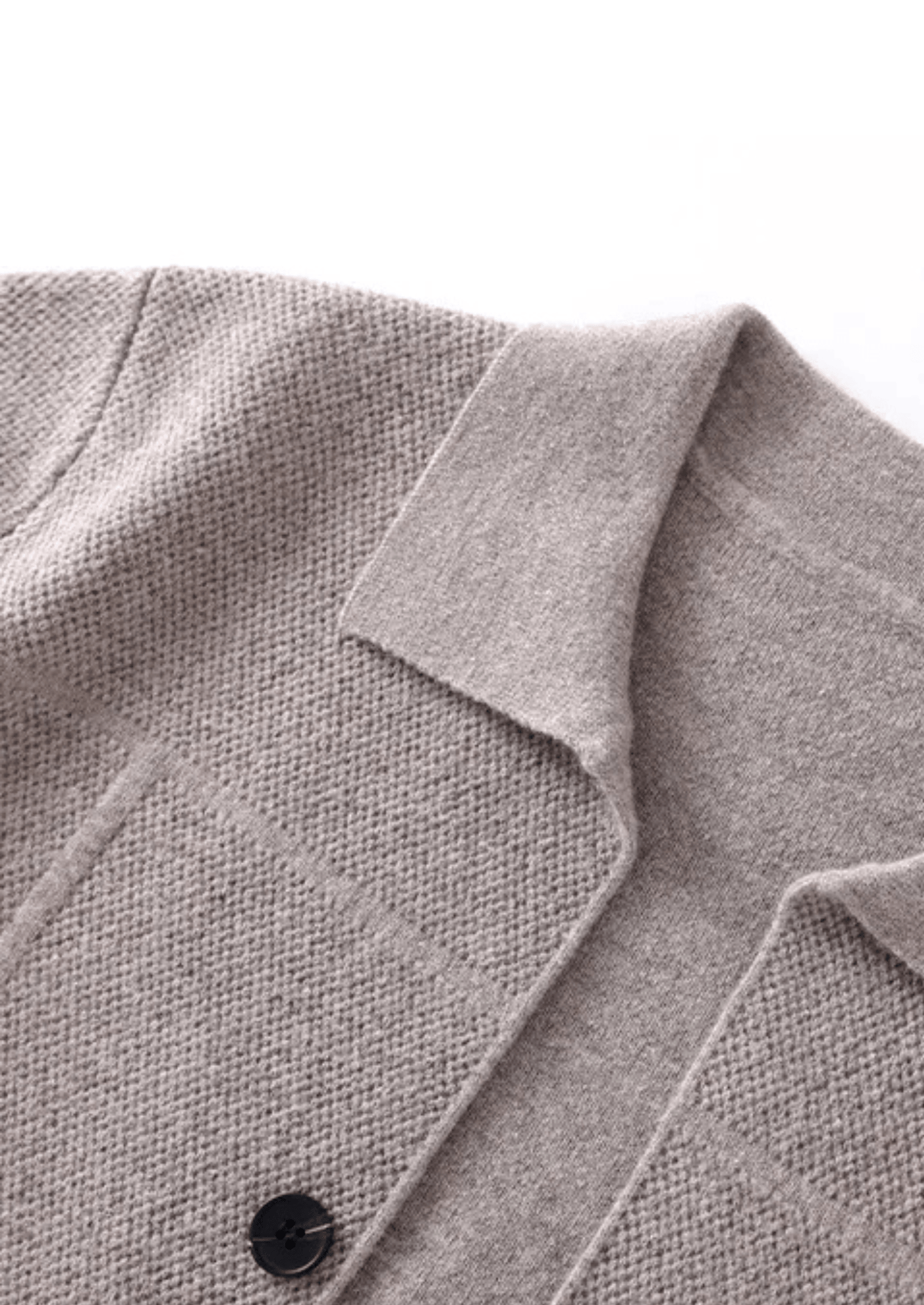 Close-up of a gray coat collar with a button on a white background