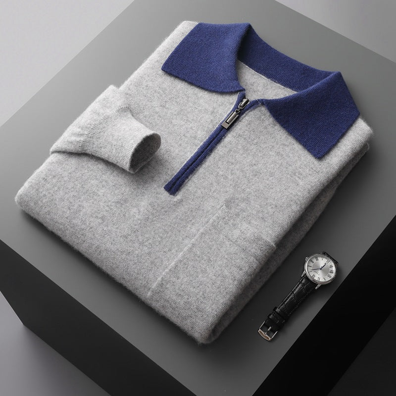 Gray sweater with blue collar and a watch on a dark surface