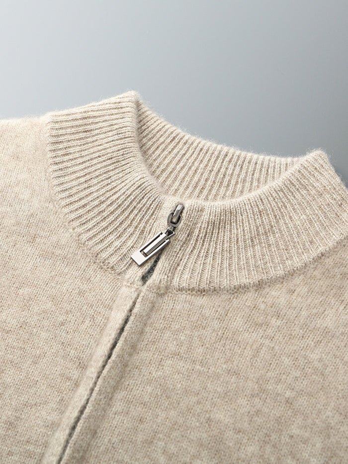 Close-up of a beige merino wool sweater with a zipper on a gray background