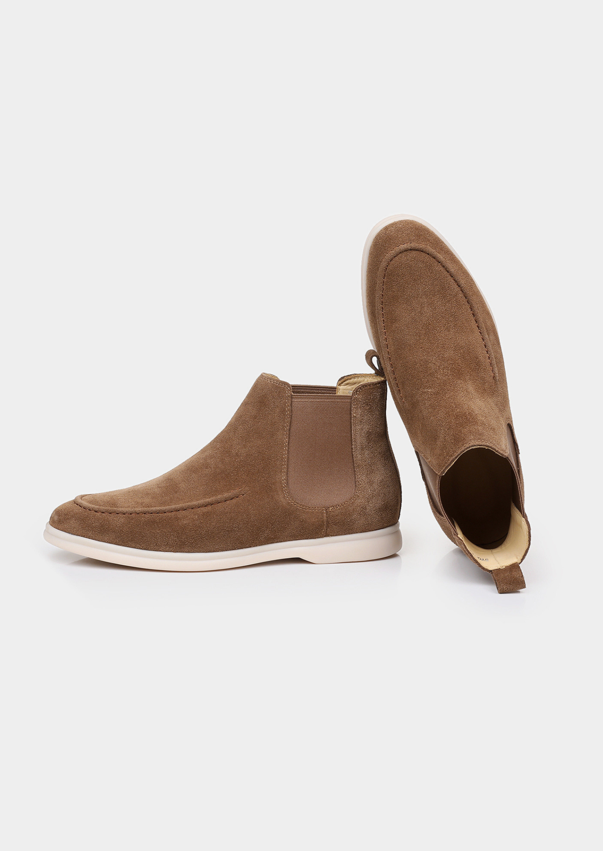 Pair of men brown sheepskin suede Chelsea boots with elastic side panels and off-white sole