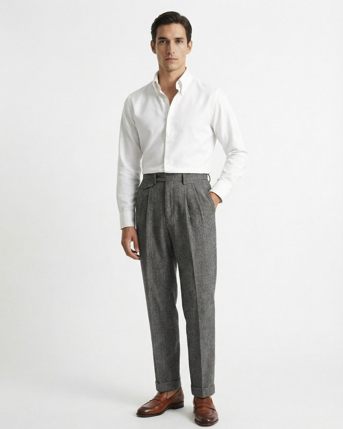 Man wearing grey houndstooth merino wool double pleated trousers with white dress shirt and leather loafers