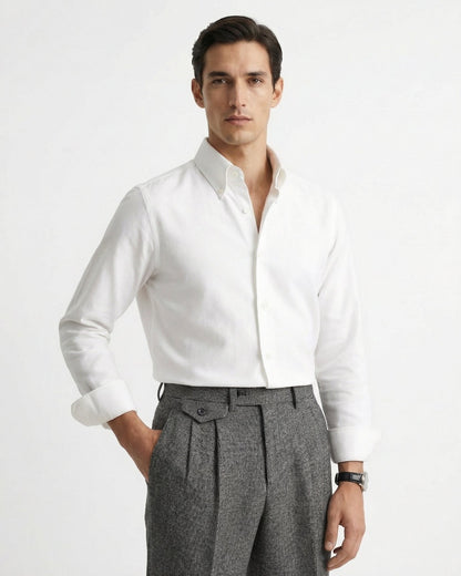 Man wearing grey houndstooth merino wool double pleated trousers with white dress shirt and leather loafers