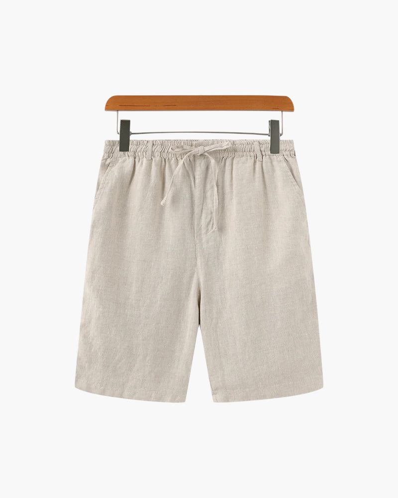 Men's beige linen shorts featuring an adjustable drawstring waistband and a refined tailored mid-thigh length.