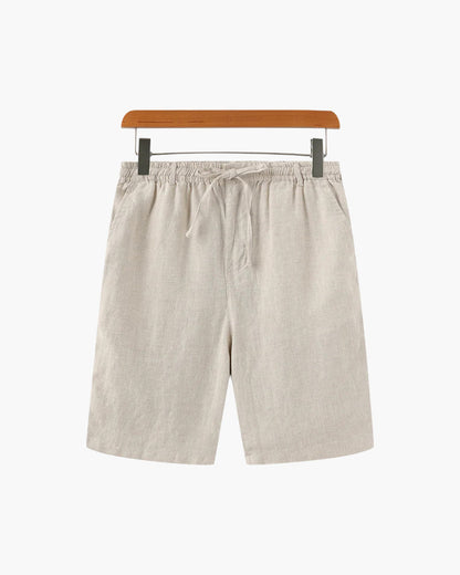 Men's beige linen shorts featuring an adjustable drawstring waistband and a refined tailored mid-thigh length.