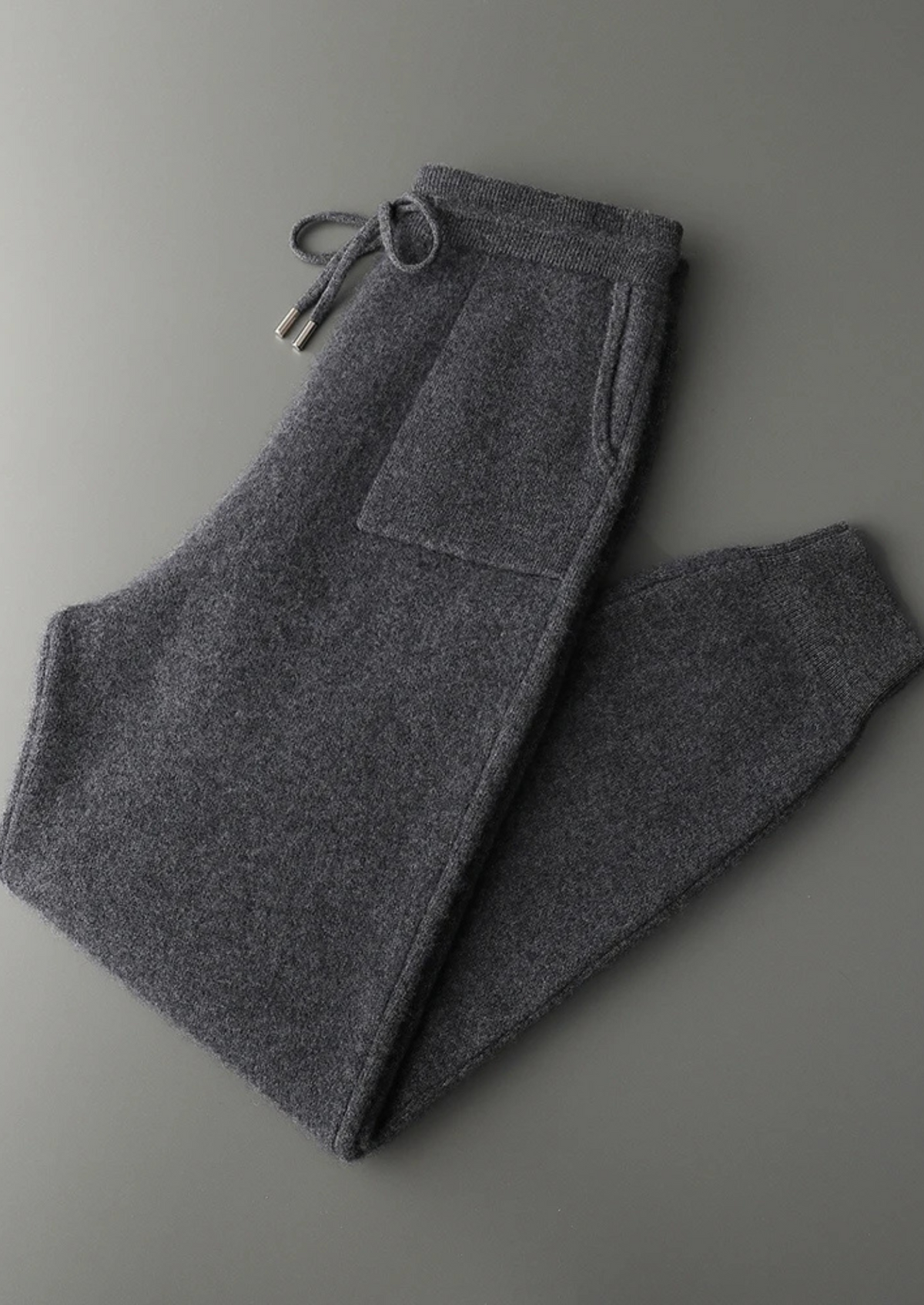 Dark grey 100% cashmere knit hoodie and matching cuffed drawstring joggers leisure set.