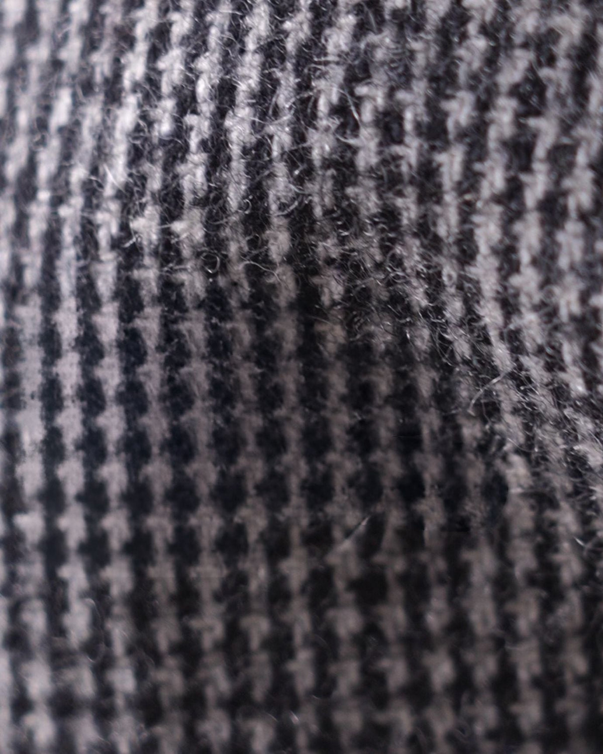 Close-up of a textured gray fabric with a checkered pattern