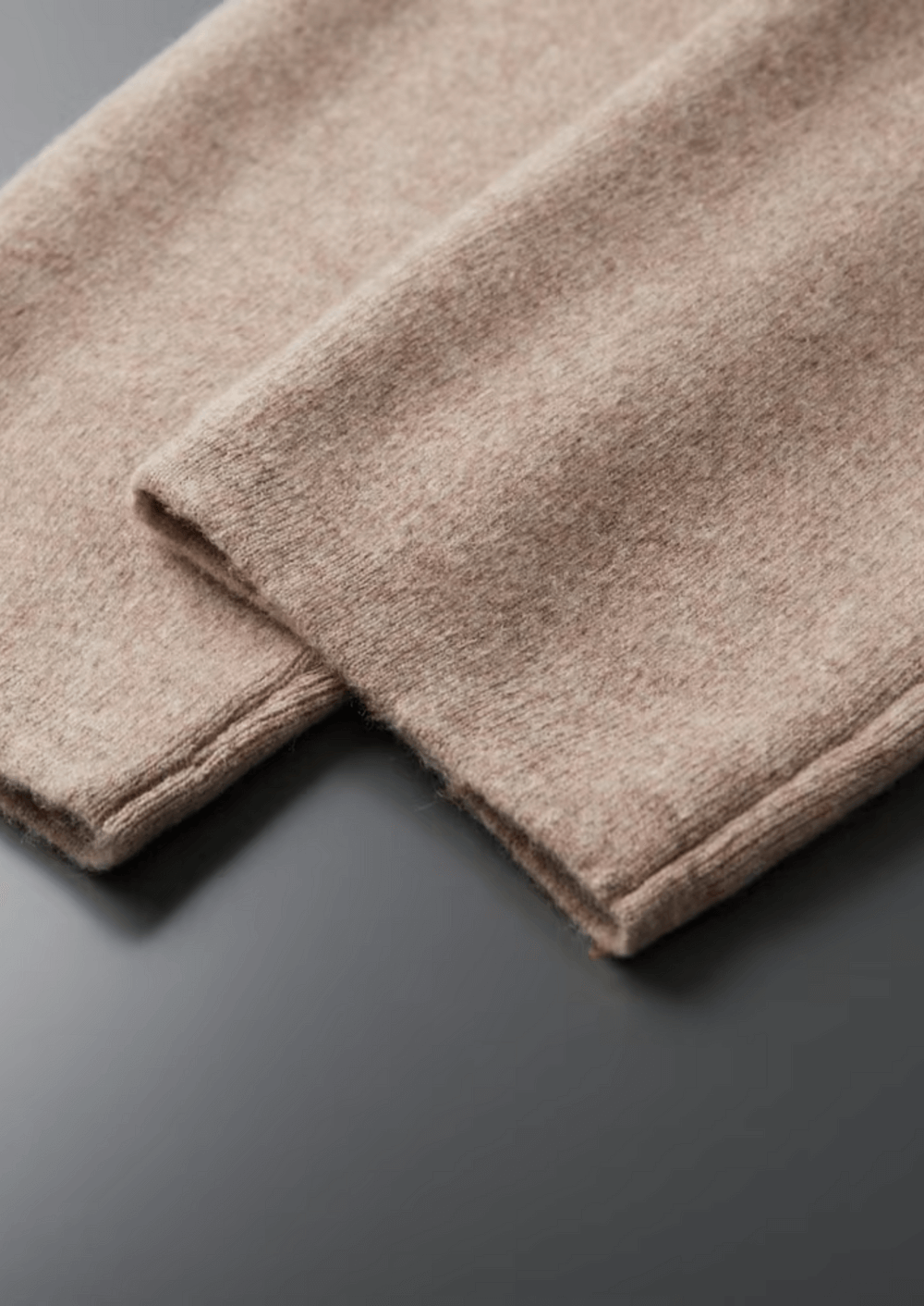 Folded beige towel on a dark surface