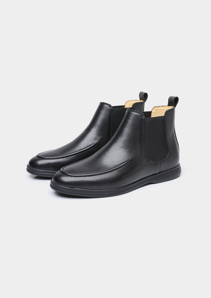 Pair of men smooth black leather Chelsea boots with moccasin apron toe stitching and black rubber sole