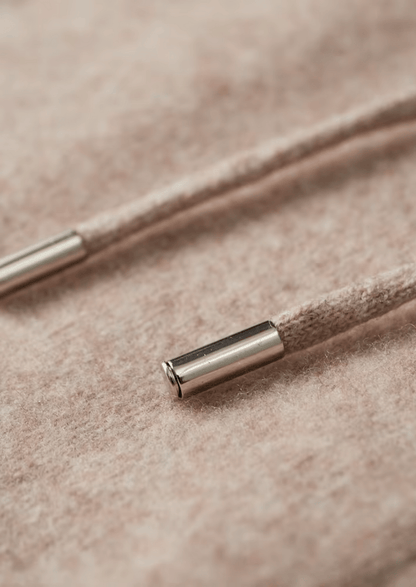 Close-up of a metal cable end cap on beige fabric