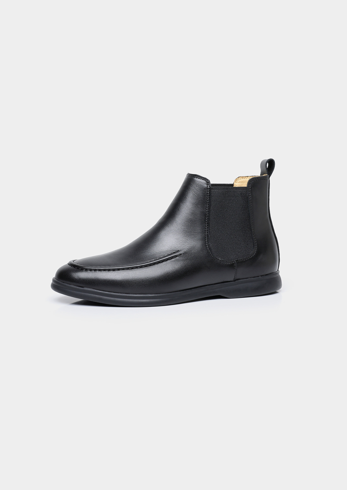 Pair of men smooth black leather Chelsea boots with moccasin apron toe stitching and black rubber sole