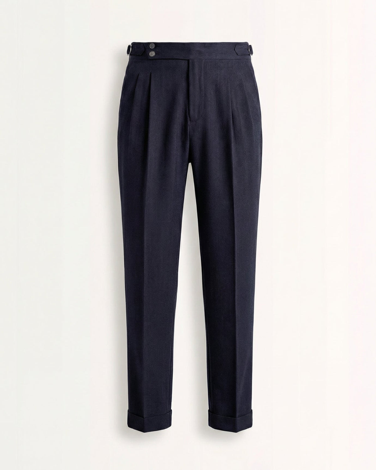 Tailored navy blue double pleated high waisted trousers with side adjusters and cuffed hem front view