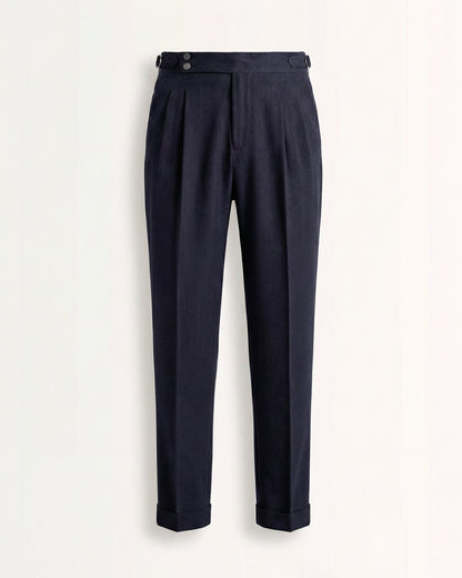 Tailored navy blue double pleated high waisted trousers with side adjusters and cuffed hem front view