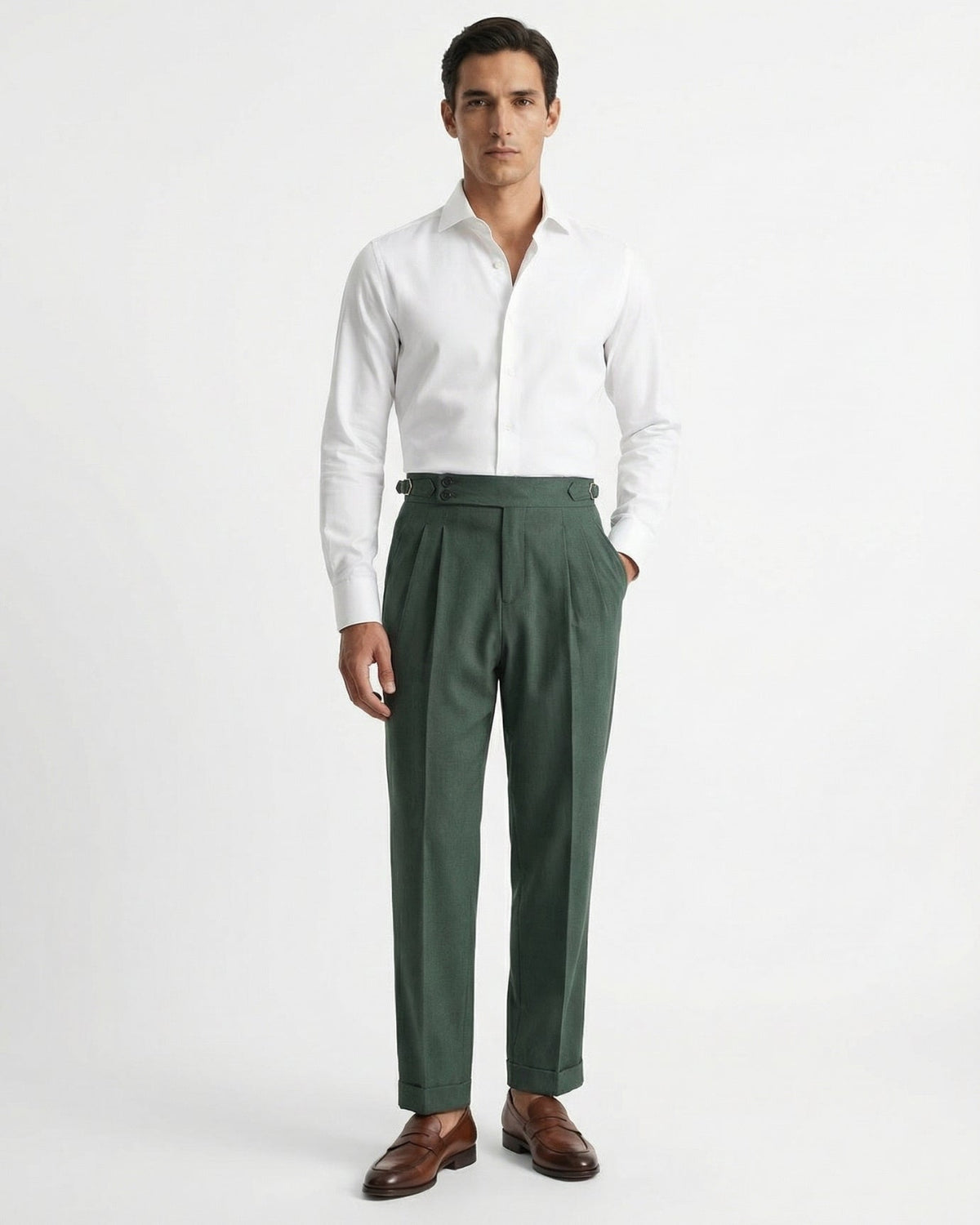 Men's forest green double-pleated cotton blend trousers showing extended crossover button waistband and side buckle