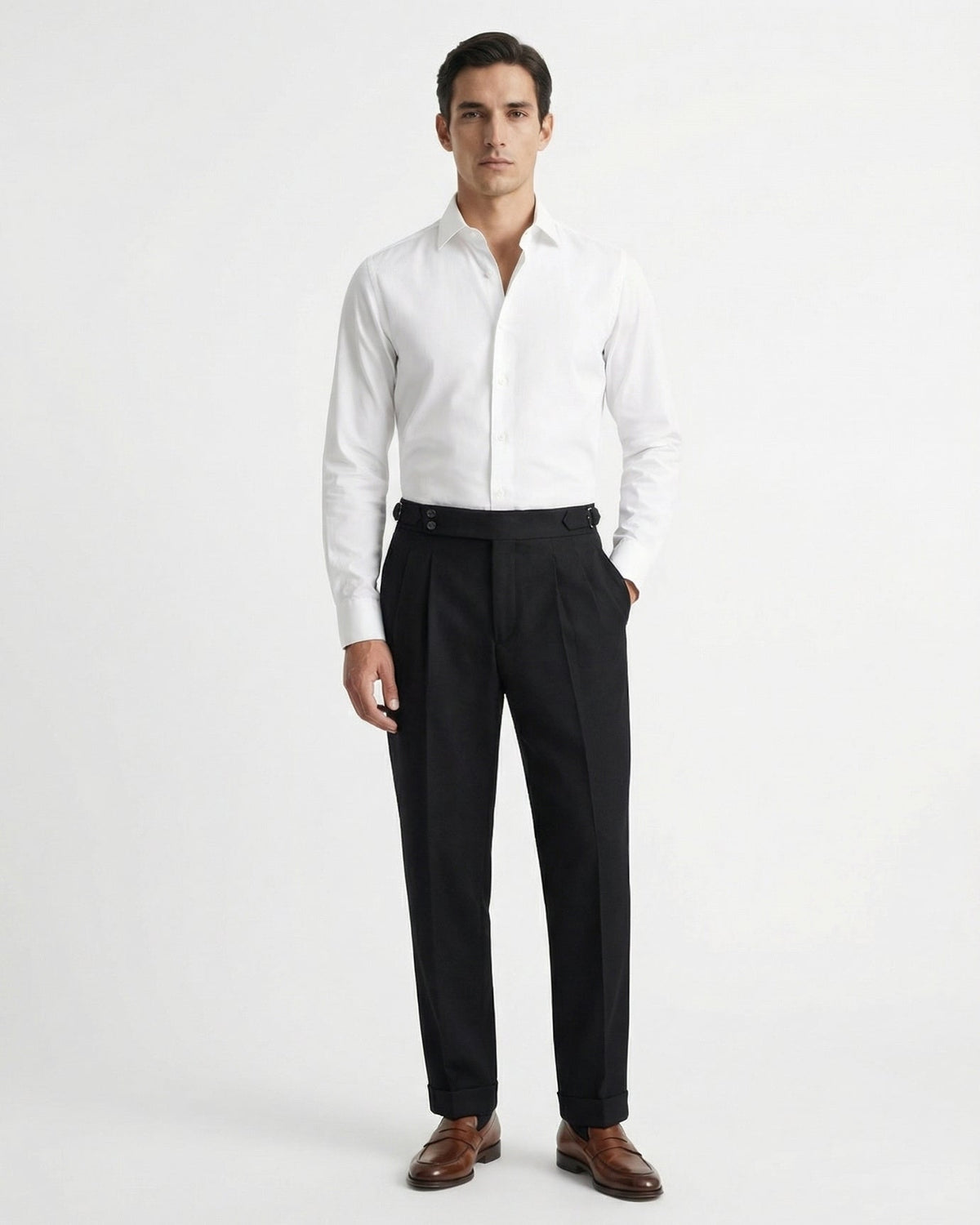 Men's black double-pleated cotton blend trousers showing extended crossover button waistband and side buckle