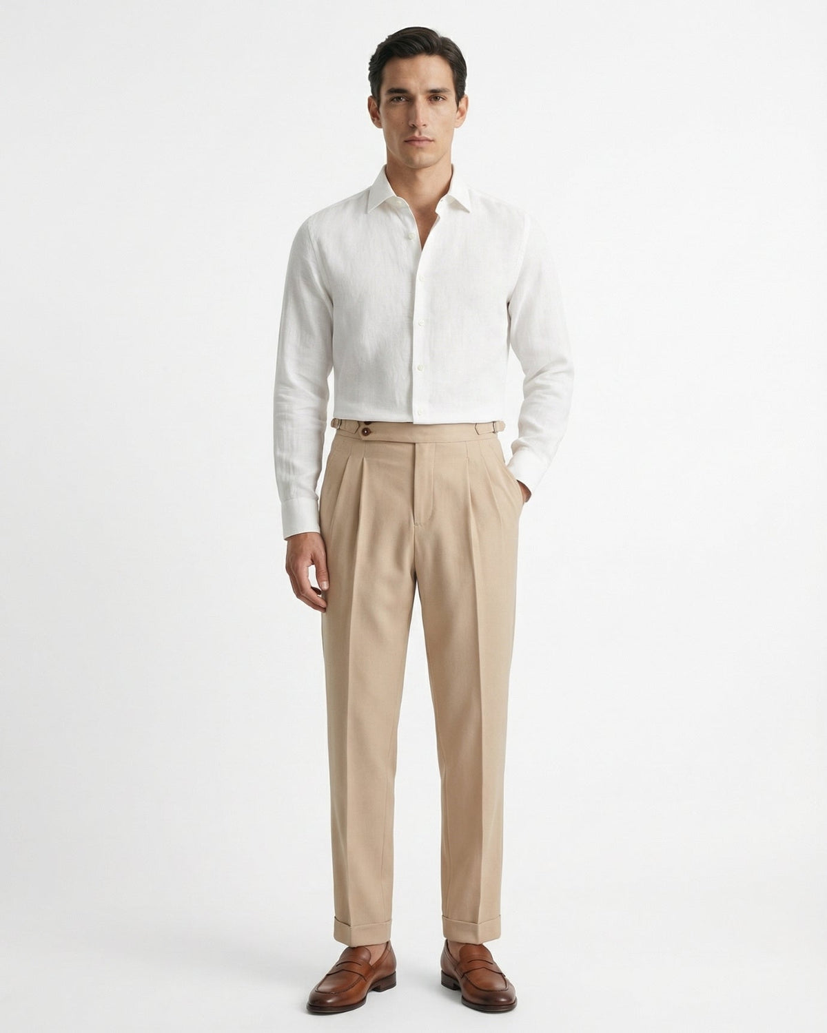 Men's beige double-pleated cotton blend trousers showing extended crossover button waistband and side buckle