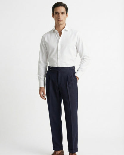 Men's tailored navy blue double pleated high waisted trousers with side adjusters and cuffed hem front view