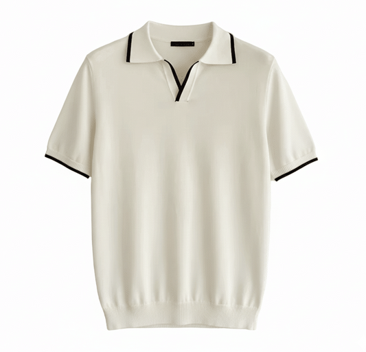 Men's white knit V-neck polo with black contrast tipping on the collar and sleeves, styled for a refined summer look.