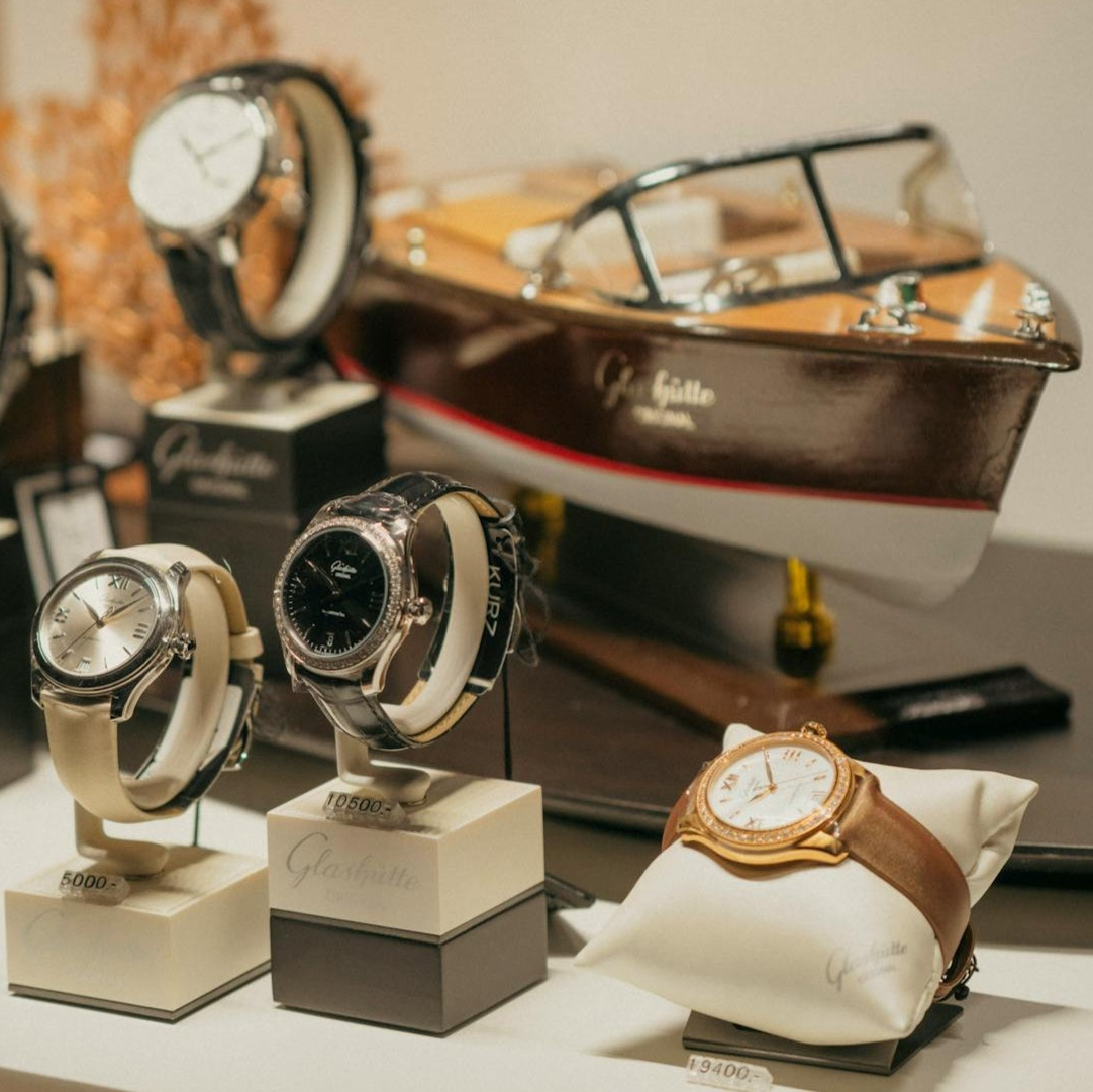 Watches on display with a boat model in the background