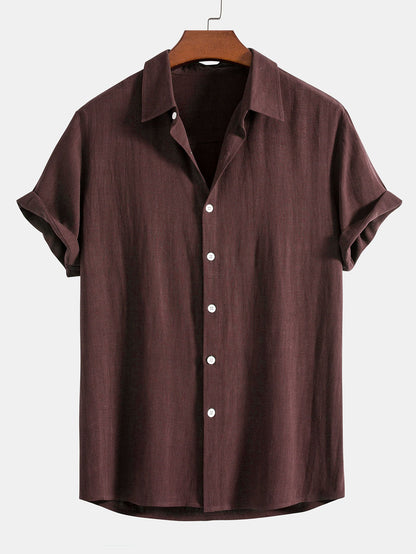 Brown short-sleeve shirt on a hanger against a white background