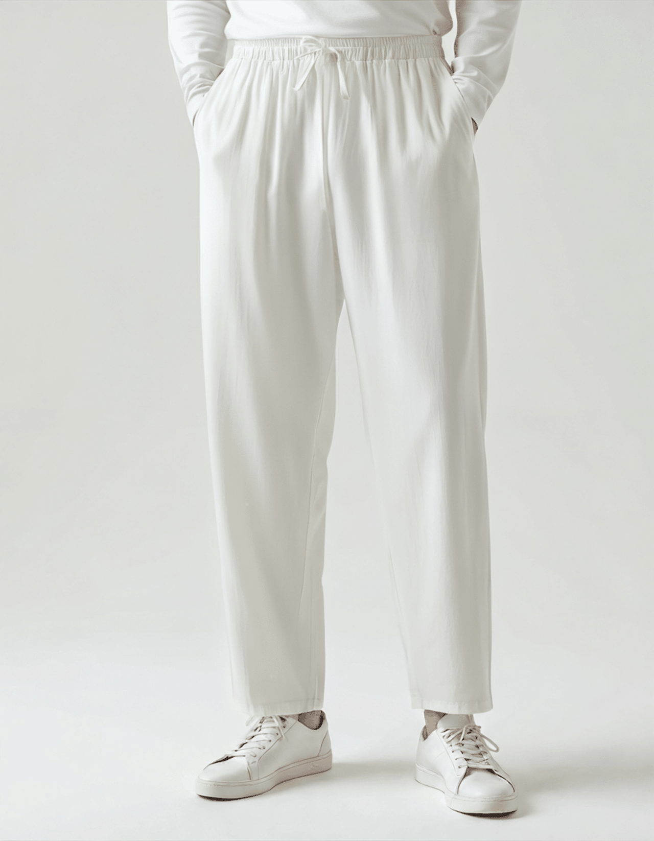Premium Men's white linen trousers showcasing a crisp, breathable natural weave and professional finished hems.