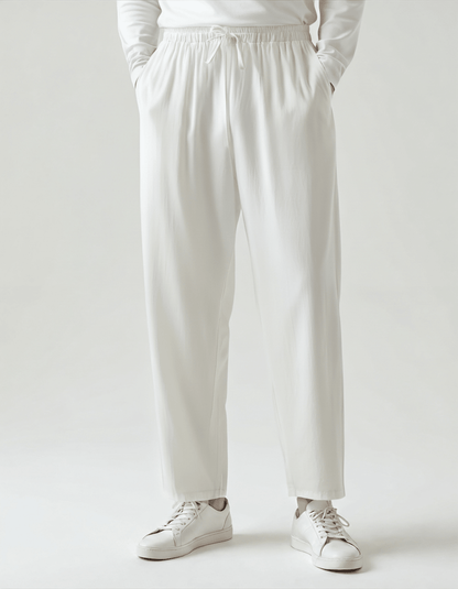 Premium Men's white linen trousers showcasing a crisp, breathable natural weave and professional finished hems.