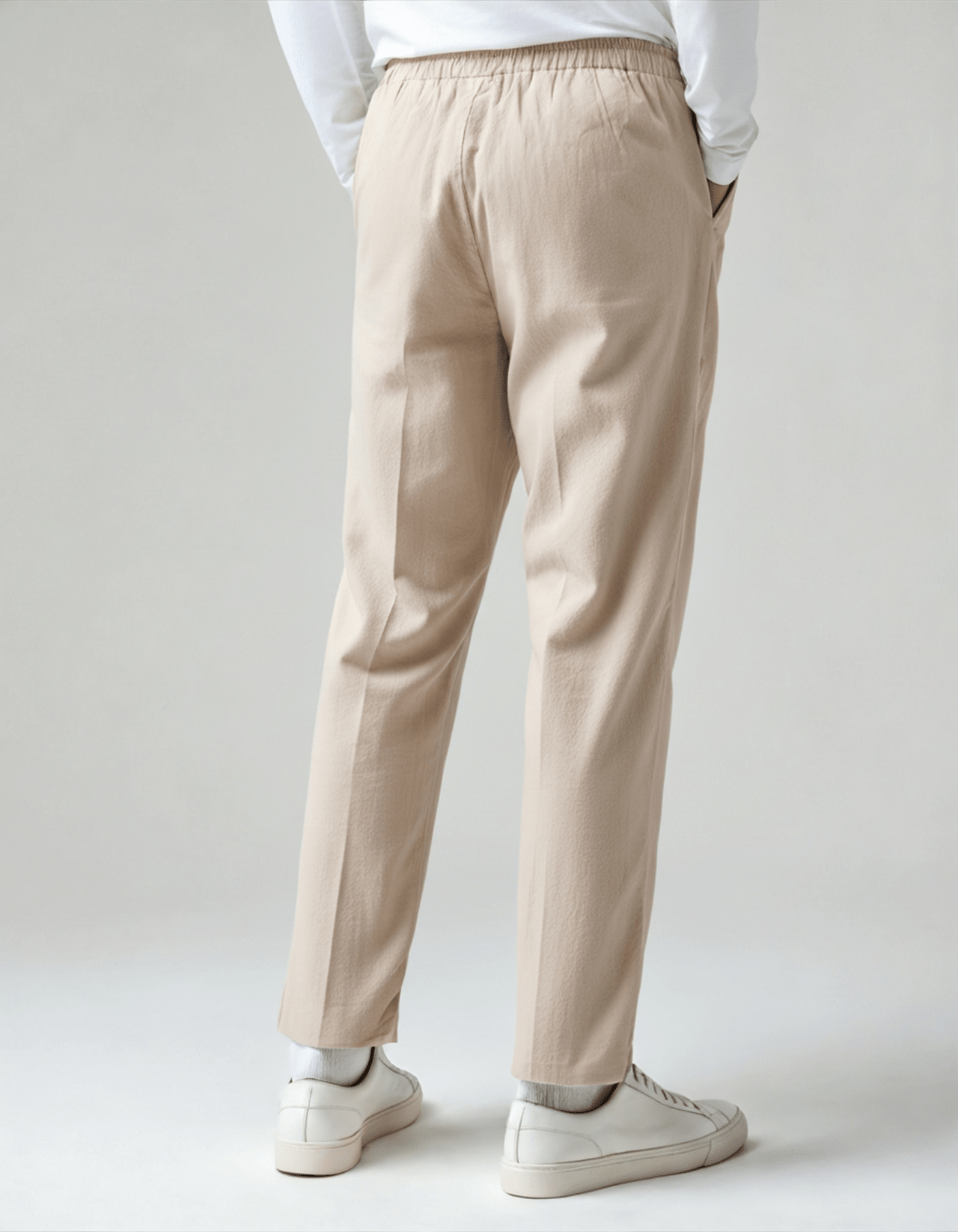Men's beige relaxed linen pants featuring a comfortable elasticated drawstring waist and a tailored straight-leg silhouette.