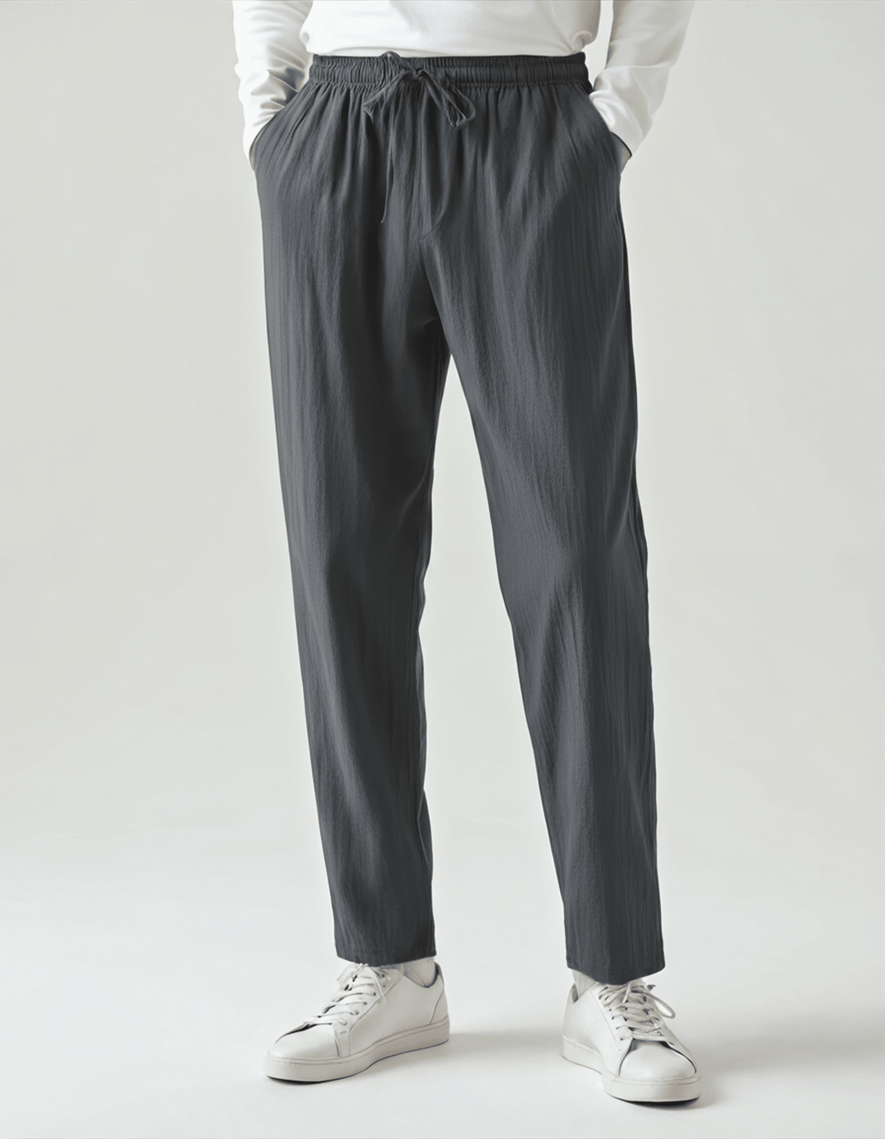 Men's charcoal gray linen trousers featuring a lightweight, moisture-wicking fabric and an ergonomic relaxed fit.