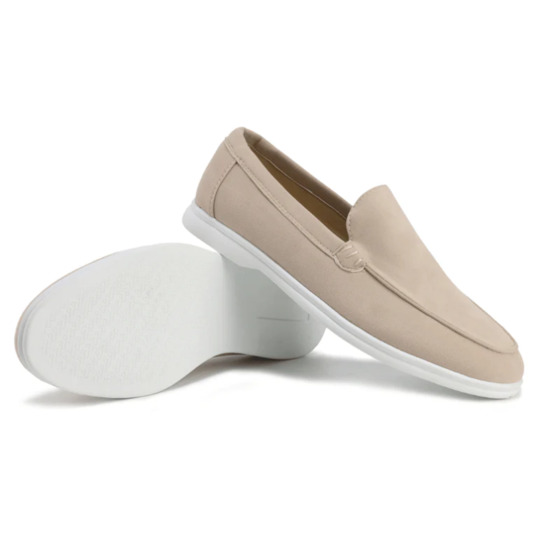Beige slip-on shoes with white soles on a white background