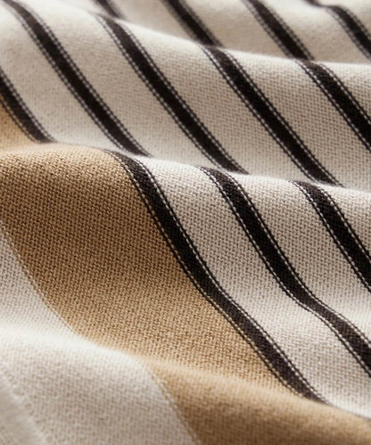 Close-up of striped fabric with brown, beige, and black lines.