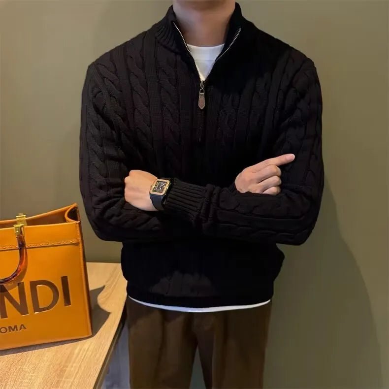 Sophisticated black cotton cable-knit quarter-zip with a signature leather detail pull, providing a sharp and comfortable cool profile.