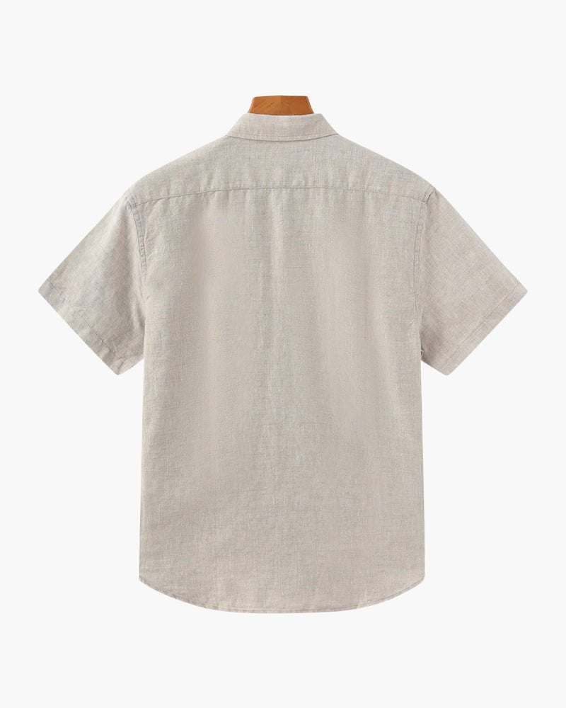 Men's beige short sleeve linen shirt featuring a natural slub texture, chest pocket, and a relaxed tailored fit.