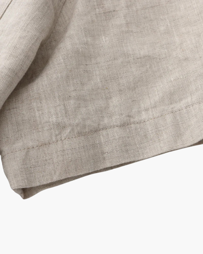 Men's beige short sleeve linen shirt featuring a natural slub texture, chest pocket, and a relaxed tailored fit.