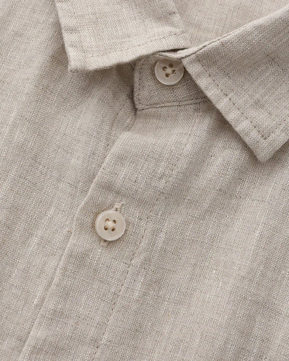 Men's beige short sleeve linen shirt featuring a natural slub texture, chest pocket, and a relaxed tailored fit.