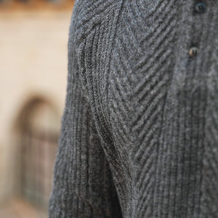 Macro view of the LORMIER multi-directional chevron and cable knit pattern, highlighting the 3D texture.