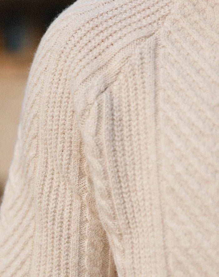 Macro view of the LORMIER multi-directional chevron and cable knit pattern, highlighting the 3D texture.
