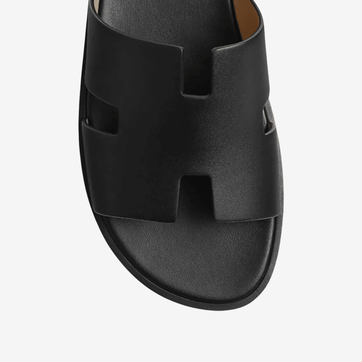 Men's black classic leather cross-strap sandals featuring a smooth finish and a padded comfort insole.