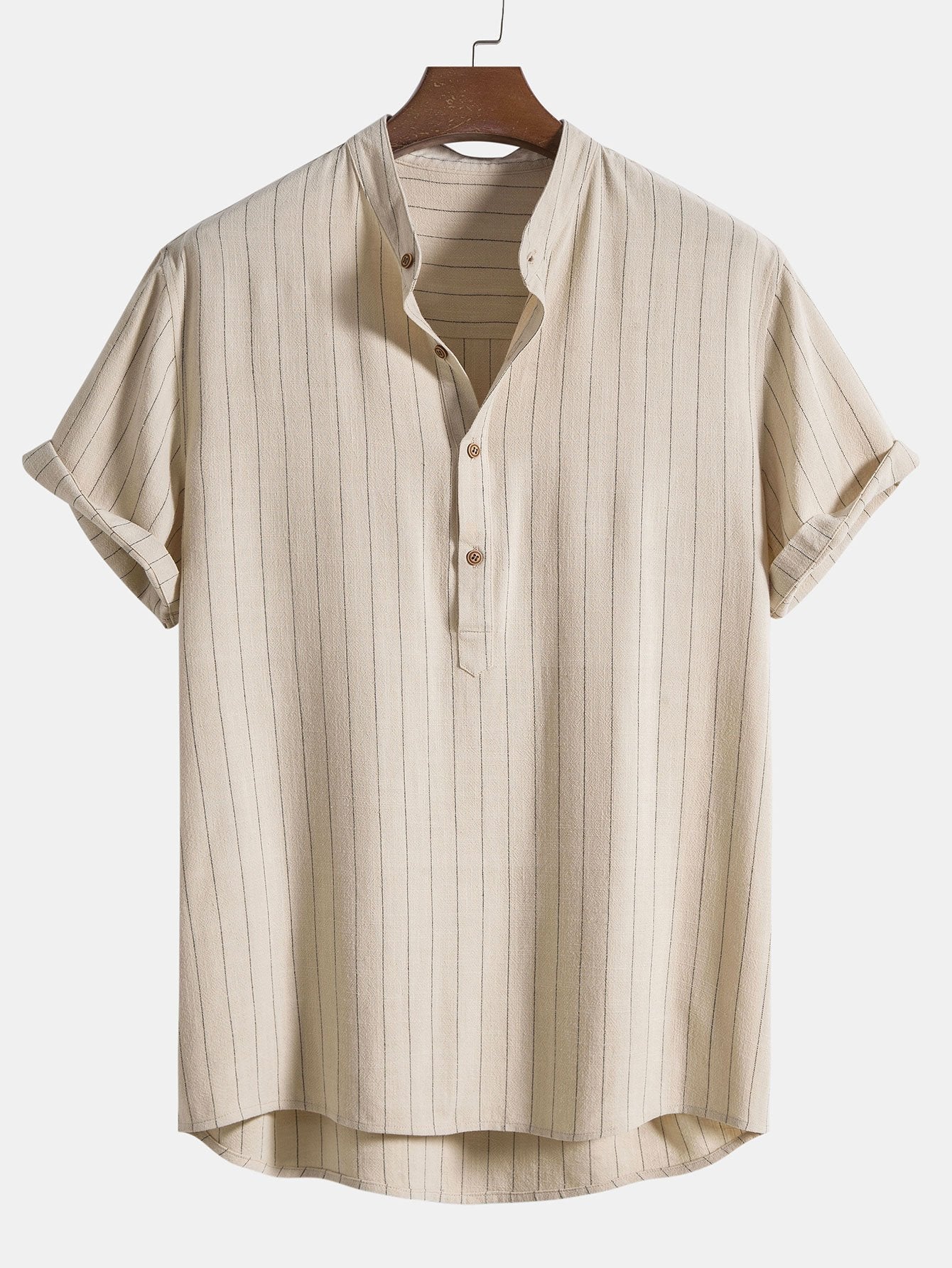 Beige striped shirt on a hanger against a white background
