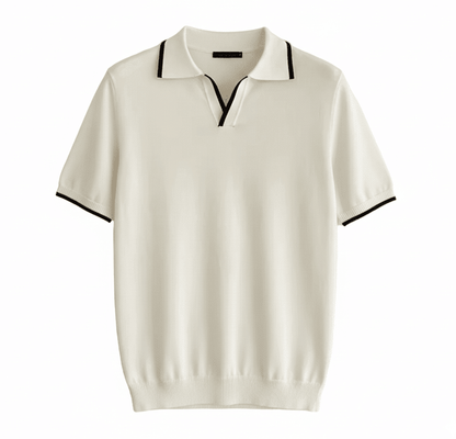 Men's white knit V-neck polo with black contrast tipping on the collar and sleeves, styled for a refined summer look.