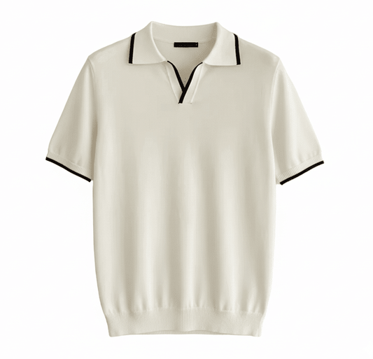 Men's white knit V-neck polo with black contrast tipping on the collar and sleeves, styled for a refined summer look.