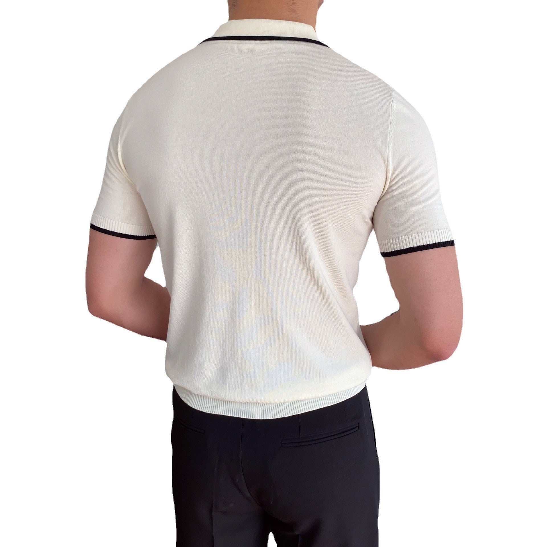 Men's white knit V-neck polo with black contrast tipping on the collar and sleeves, styled for a refined summer look.