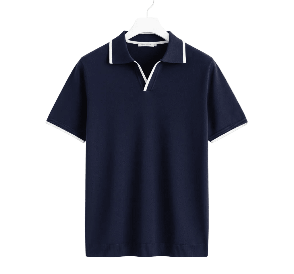 Close-up of a navy blue slim-fit cotton polo featuring a white contrast tipped V-neck collar and matching tipped sleeve cuffs.