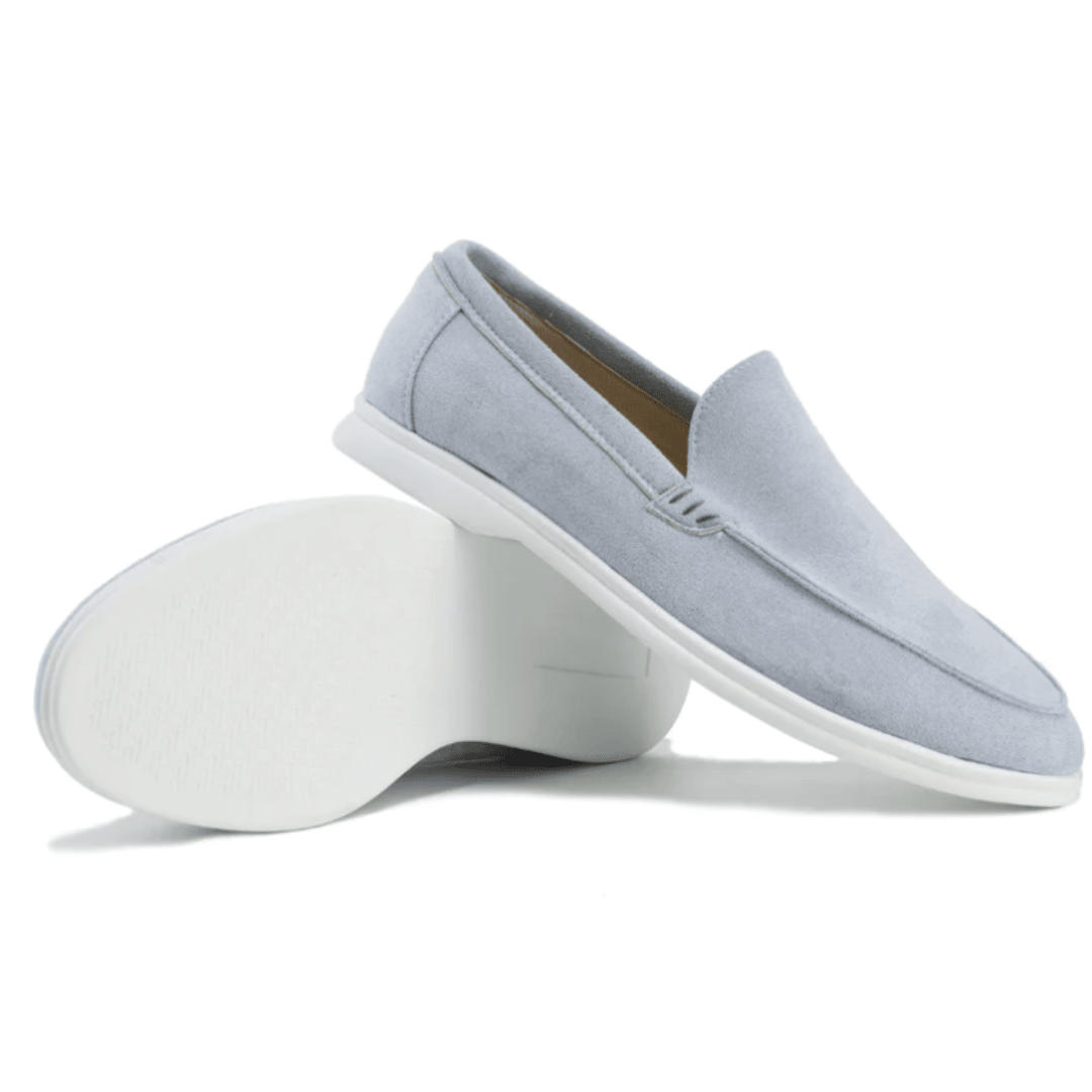 Light blue slip-on shoes with white soles on a white background