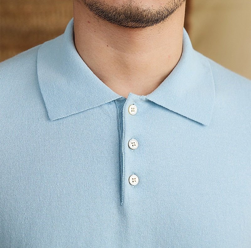 Men's light blue knit polo crafted from a breathable cotton-linen blend, featuring a classic button placket and ribbed hem.