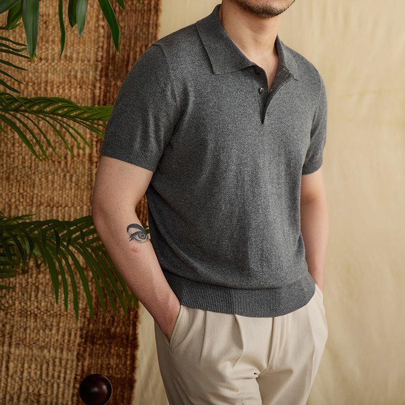 Men's dark gray premium knit polo with a professional three-button placket and a crisp, structured cotton-linen finish.